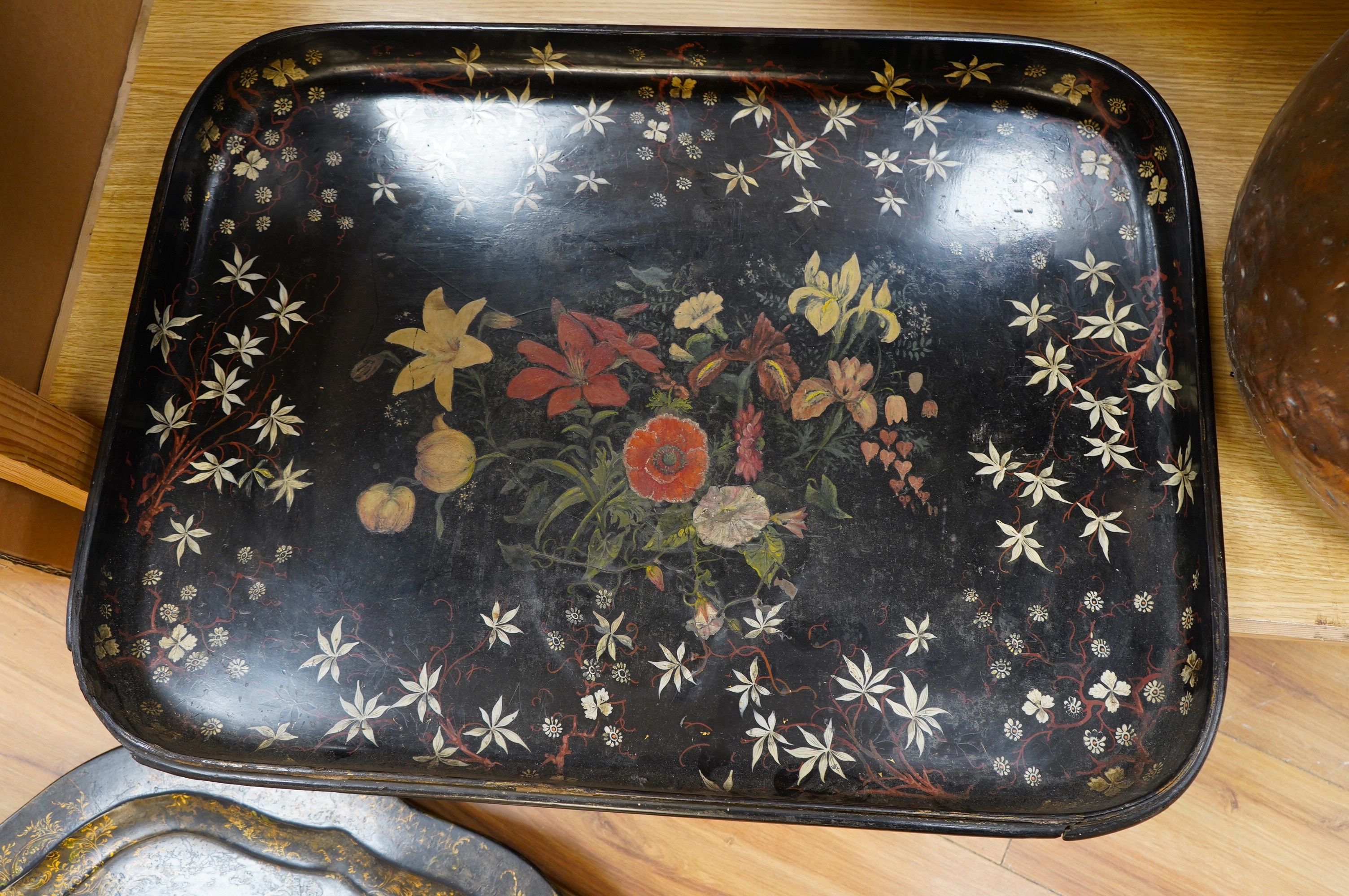 Three large Victorian papier mâché trays, largest 71cm wide. Condition - all have faults